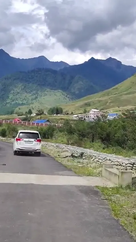 Mountain road and green hills on the journey toward Menchuka